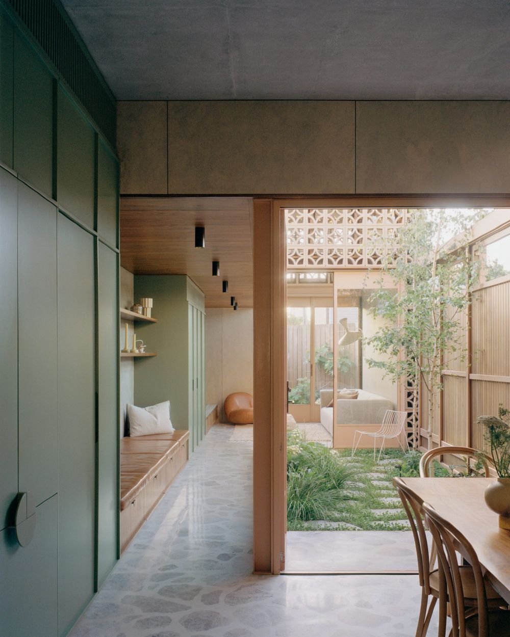 garden tower house combines a serene garden and soft hues to reinforce ...