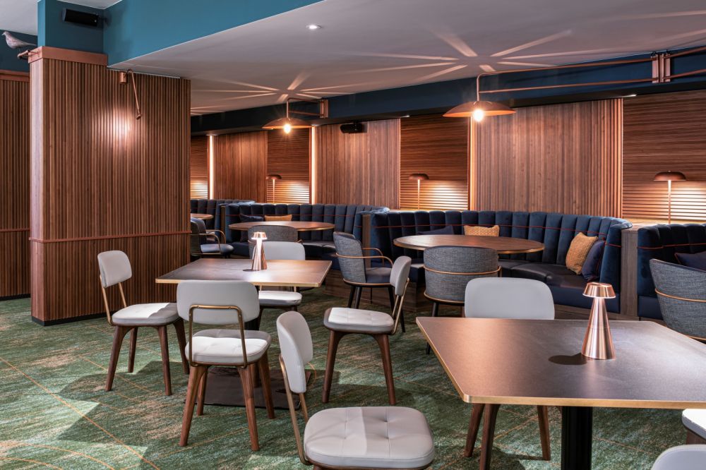 inside a retro-inspired pigeon post-bar & eatery at hilton cologne ...